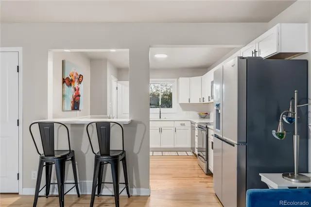 a kitchen with refrigerator and window