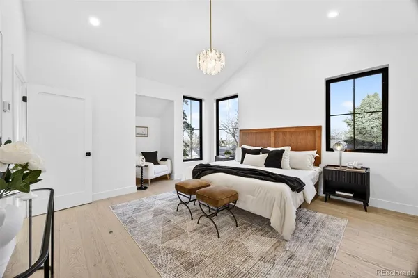 a bed room with a bed and a chandelier