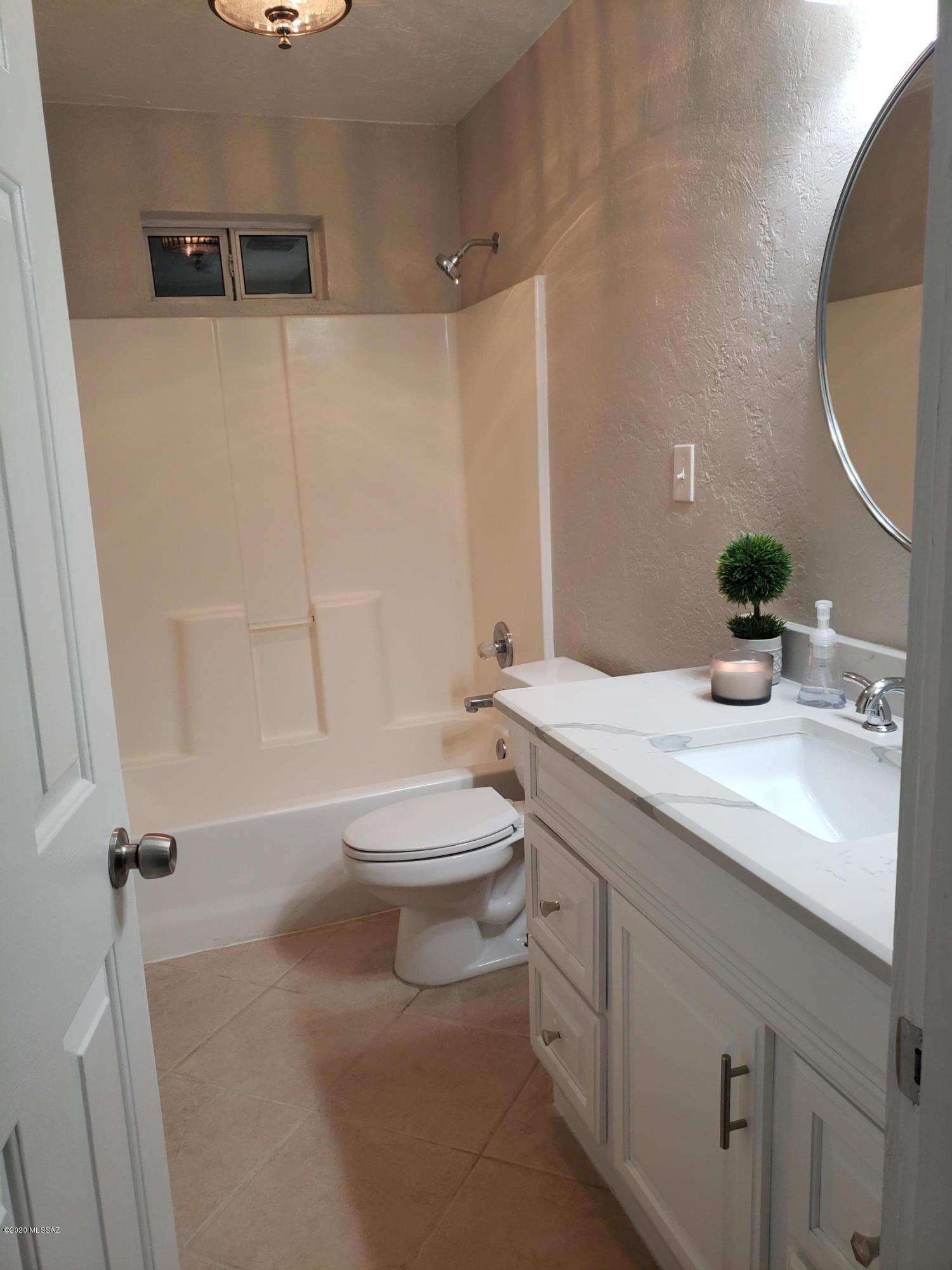 182 Pita Court Rio Rico, AZ 85648 - Photo 23 of 46 a bathroom with a sink a toilet and a mirror