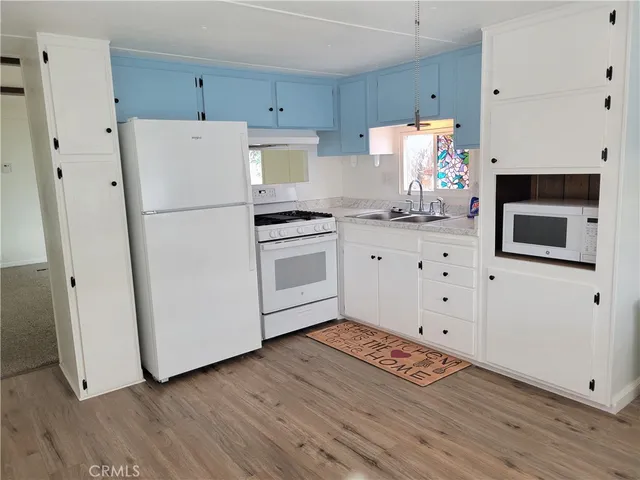 a kitchen with stainless steel appliances a refrigerator sink and cabinets