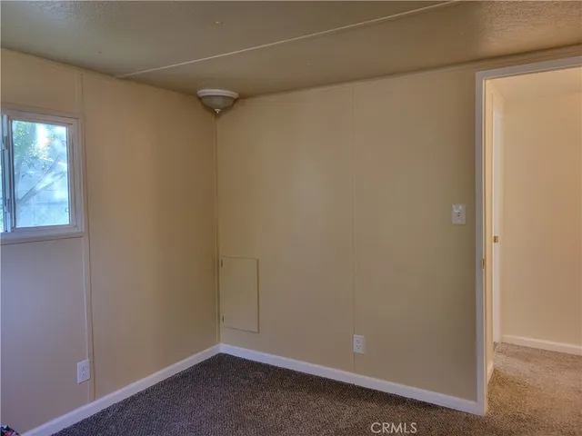 a bathroom with a granite countertop toilet a sink and a mirror
