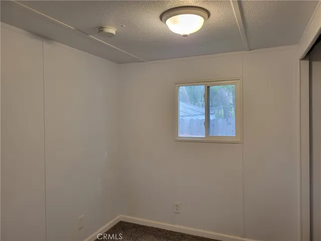 a view of a chair and table in backyard