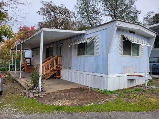 a view of house with backyard and outdoor seating