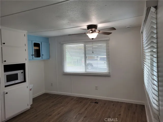 a view of an empty room with a fireplace and a window