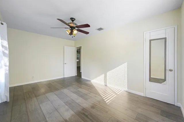 a bathroom with a granite countertop sink mirror vanity and bathtub