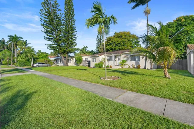 a view of house with backyard