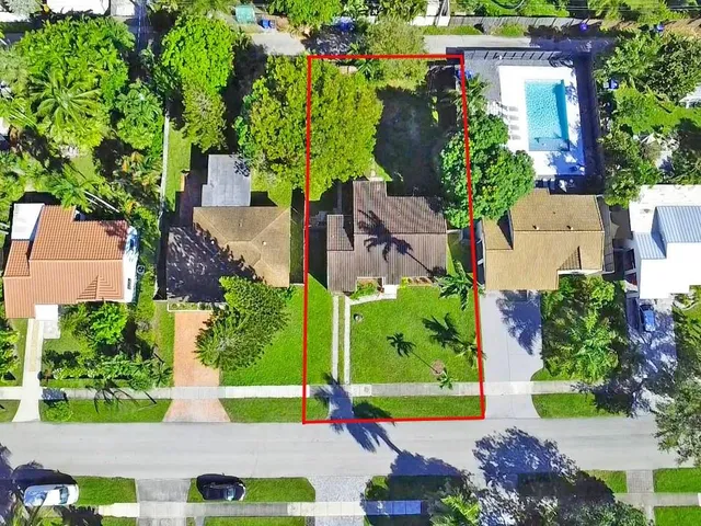 an aerial view of multiple houses with yard