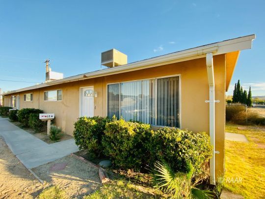 112 South Gold Canyon Street Ridgecrest, CA 93555 - Photo 1 of 8 a front view of a house with garden