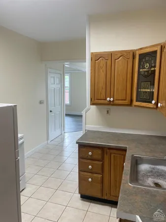 a kitchen with stainless steel appliances granite countertop a refrigerator and a stove