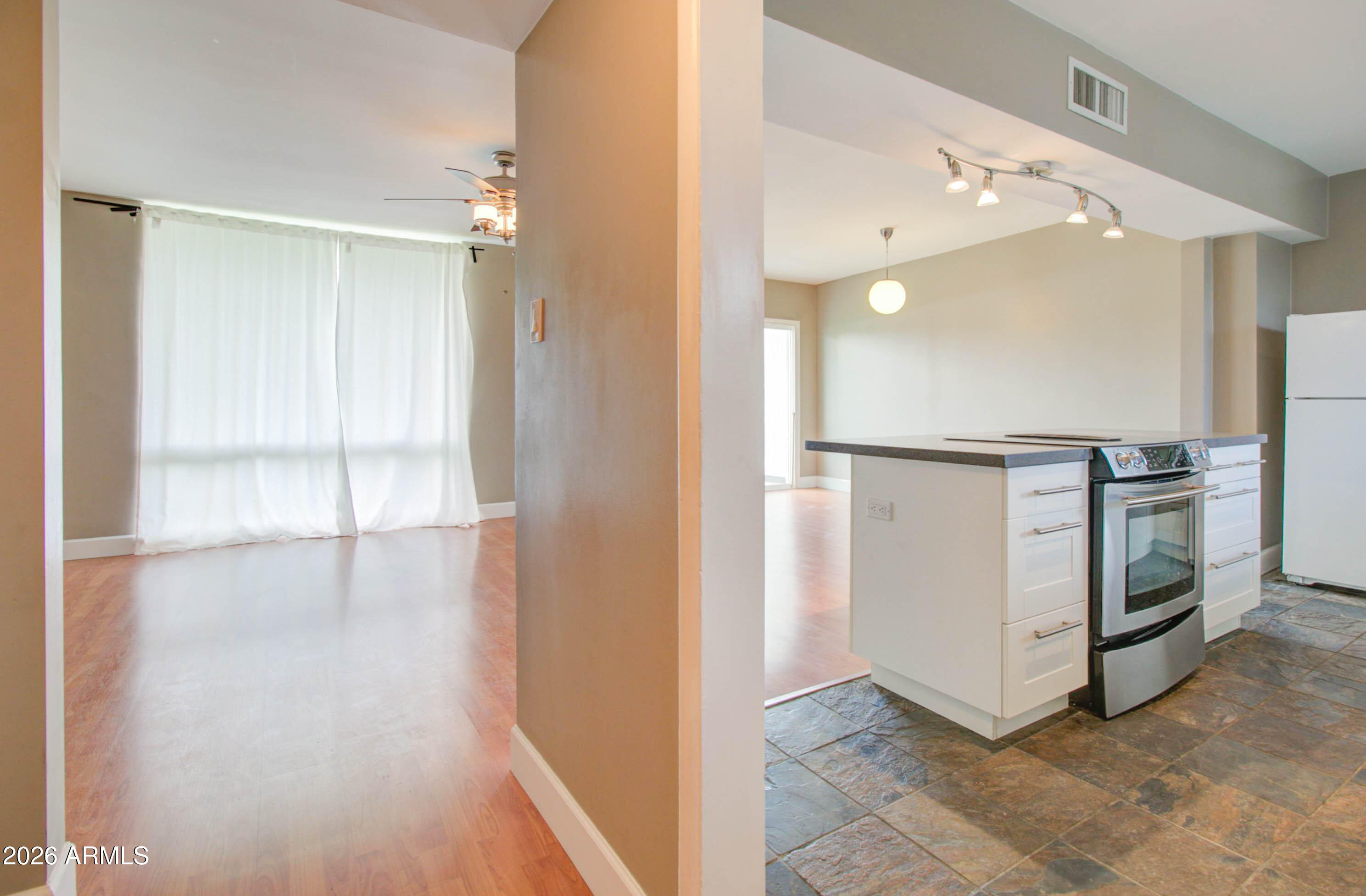 3242 East Camelback Road, Unit 207 Phoenix, AZ 85018 - Photo 6 of 25 Kitchen w/ White Shaker Cabinetry