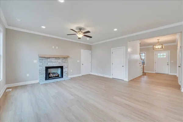 a view of an empty room with a fireplace and a window