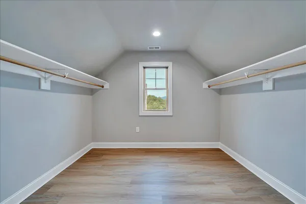 a view of a room with wooden floor and windows