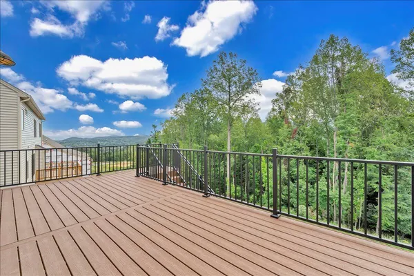a view of a balcony with wooden floor