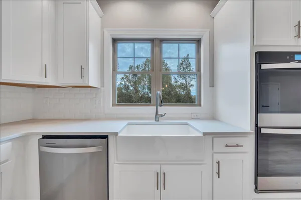 a kitchen with a sink cabinets and window
