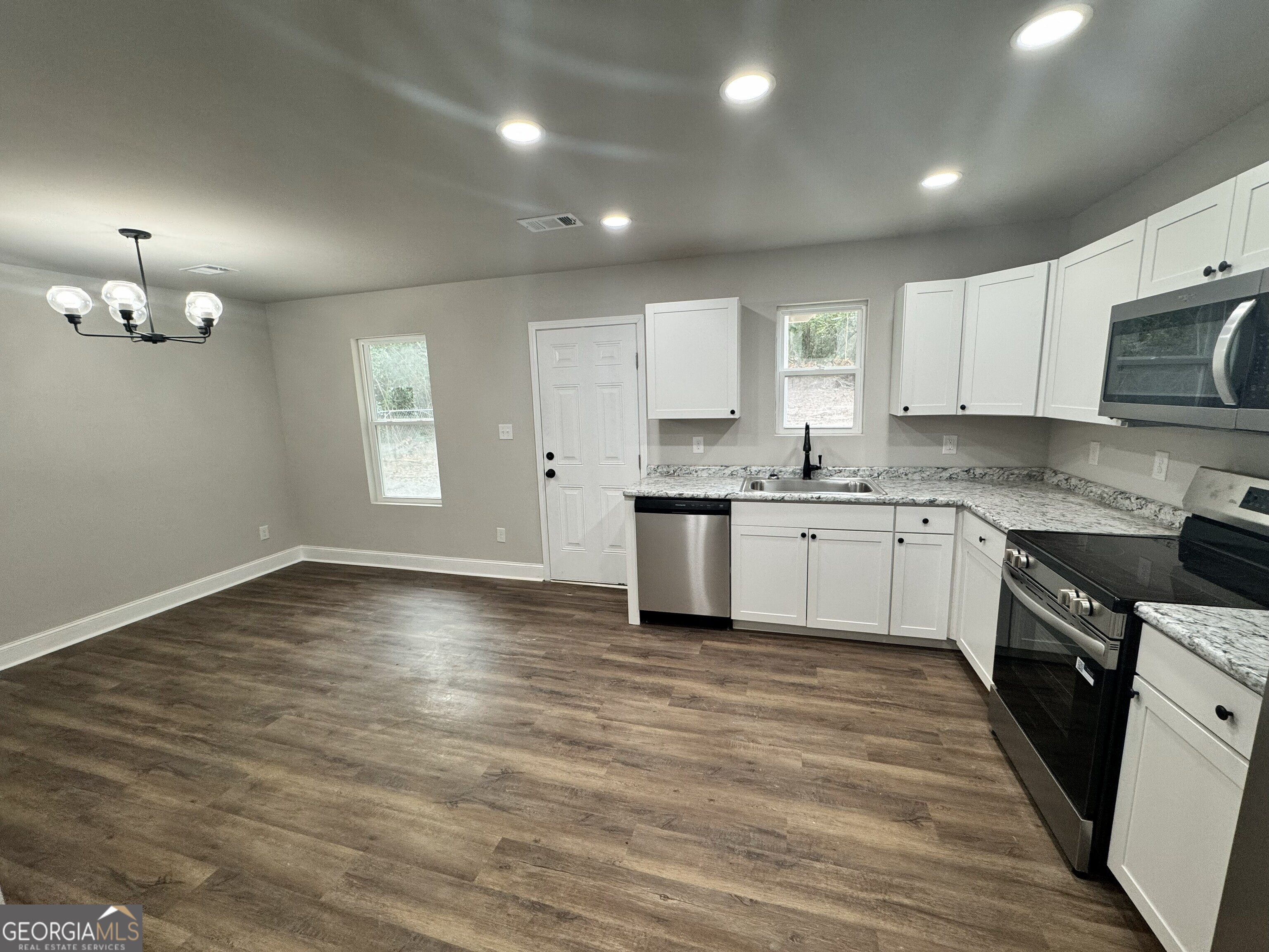 305 North 4th Street Warner Robins, GA 31093 - Photo 6 of 17 a kitchen with stainless steel appliances granite countertop a sink cabinets and wooden floor