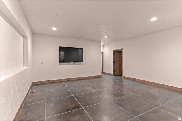 2464 East Granite Way St. George, UT 84790 - Photo 89 of 106 Empty great room featuring dark cement patterned flooring and recessed lighting