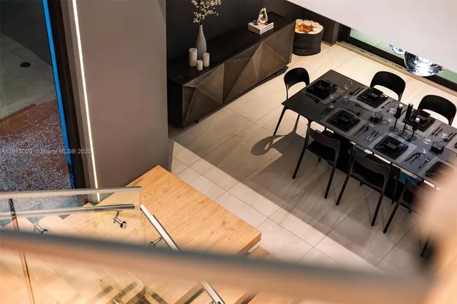 a view of a livingroom with furniture and floor to ceiling window