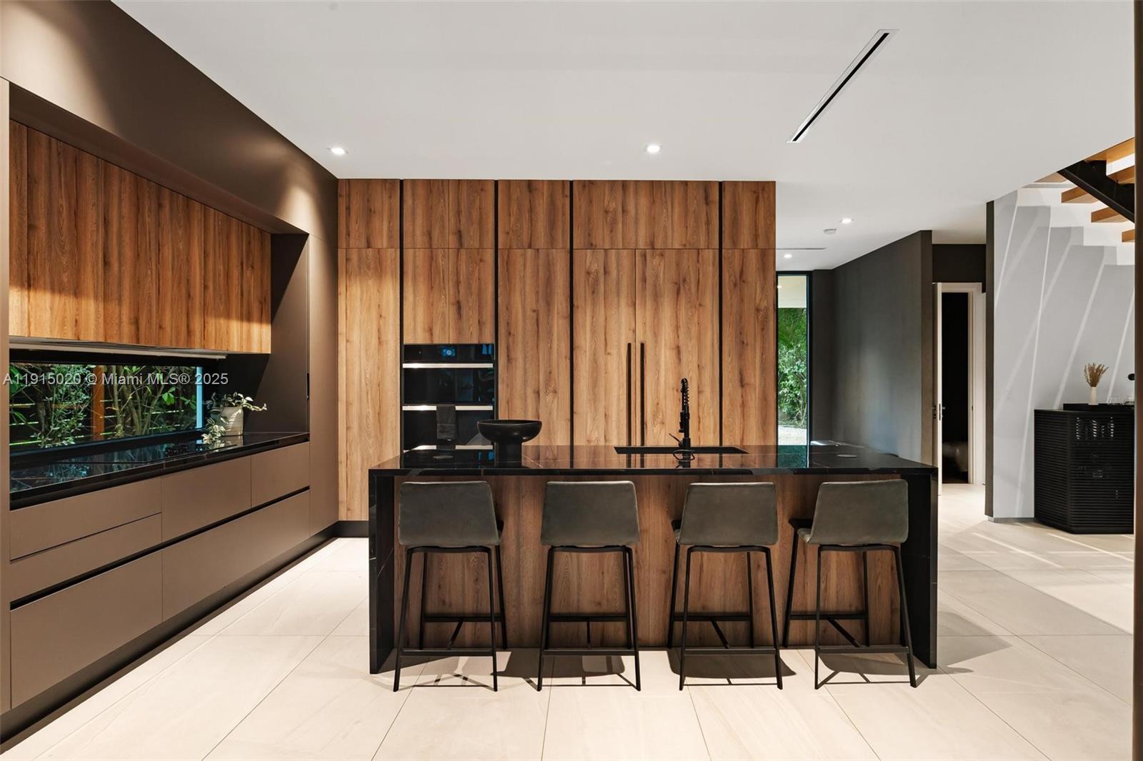 77 Southwest 18th Terrace Miami, FL 33129 - Photo 17 of 90 a kitchen with stainless steel appliances kitchen island granite countertop a refrigerator and a stove top oven