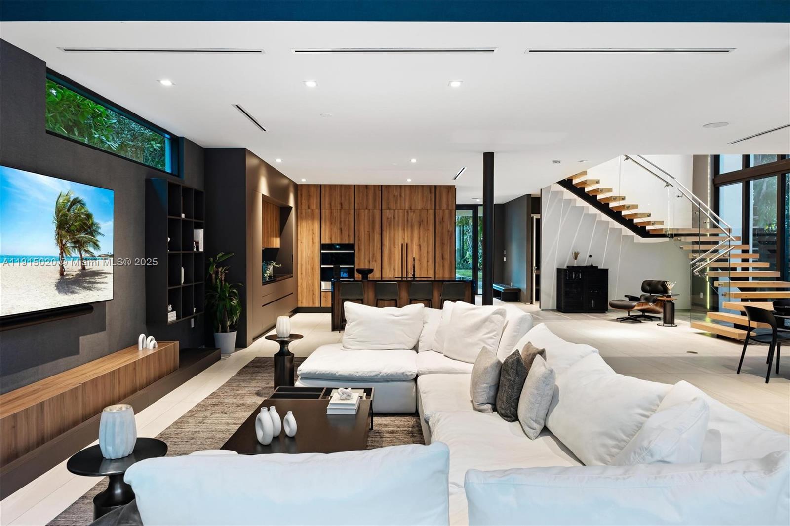 77 Southwest 18th Terrace Miami, FL 33129 - Photo 22 of 90 a living room with furniture a flat screen tv and a fireplace