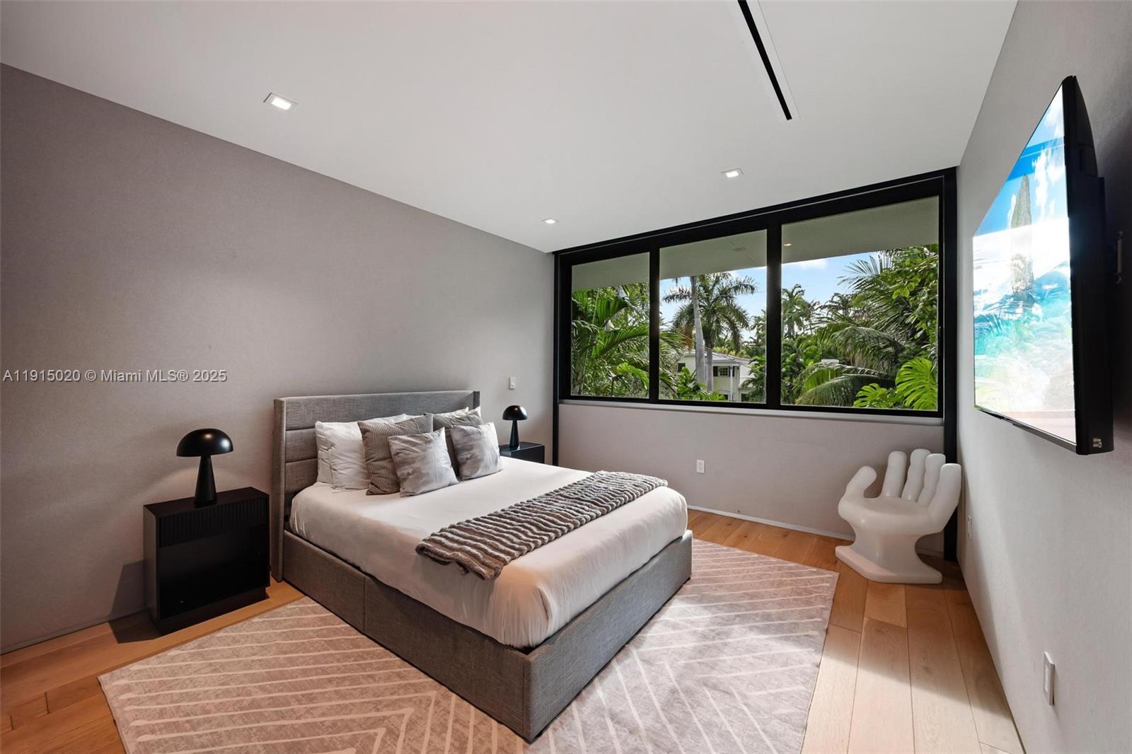 77 Southwest 18th Terrace Miami, FL 33129 - Photo 41 of 90 a bedroom with a large bed and a large window