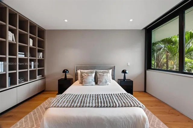 a living room with furniture and large windows