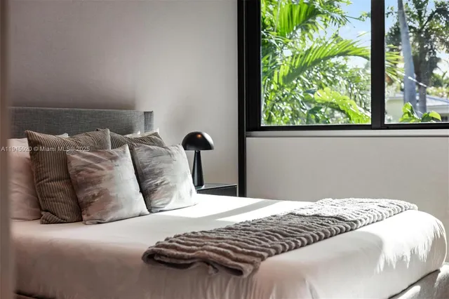 a living room with furniture a large window and a fireplace