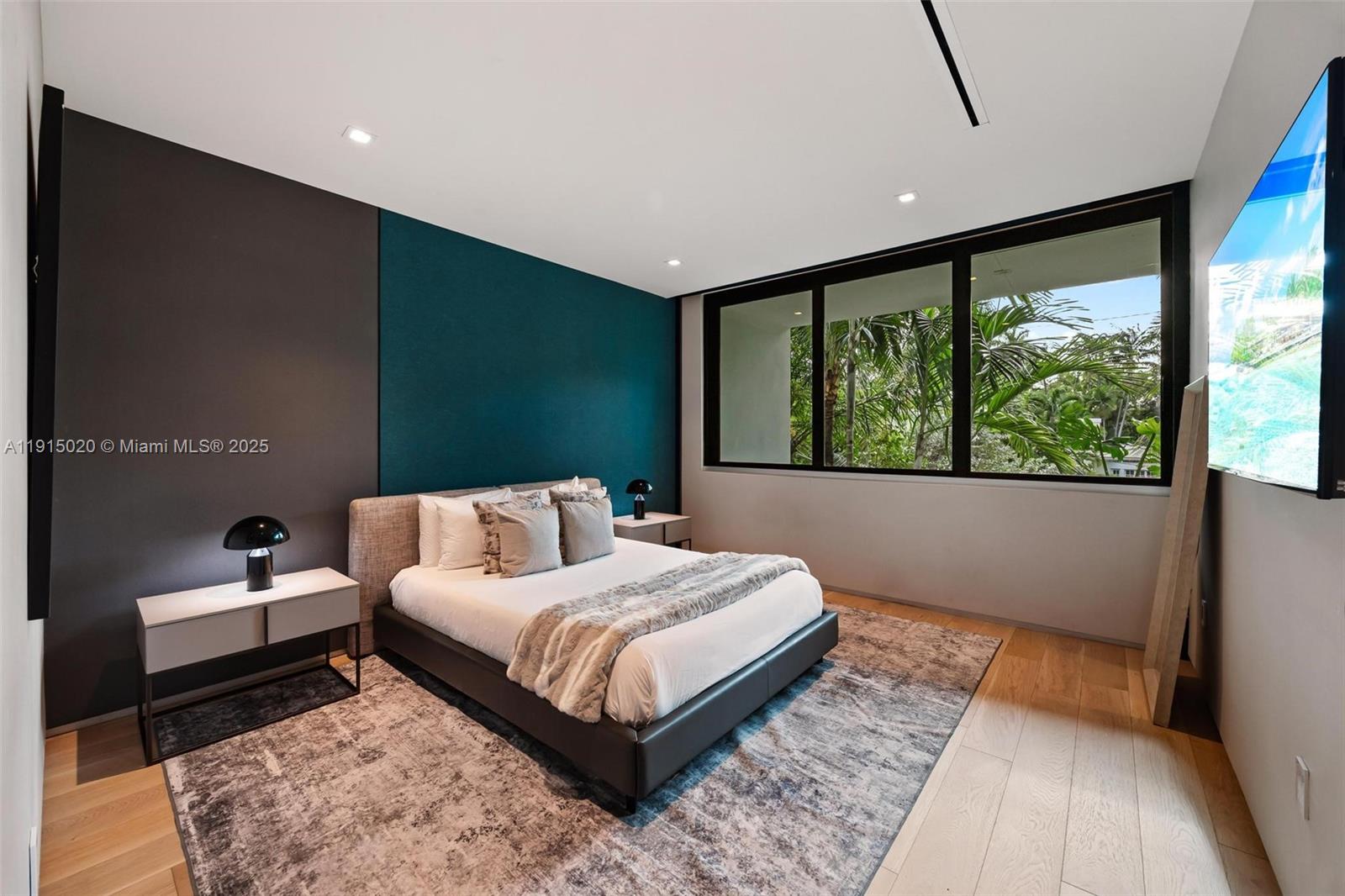 77 Southwest 18th Terrace Miami, FL 33129 - Photo 56 of 90 a bedroom with a bed and a large window