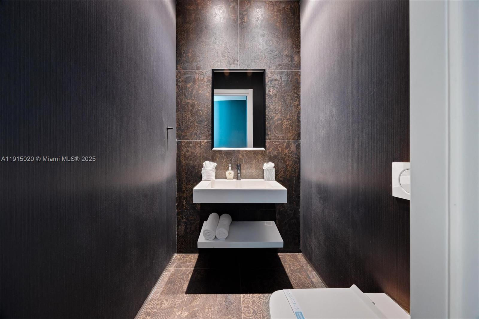 77 Southwest 18th Terrace Miami, FL 33129 - Photo 71 of 90 a bathroom with a sink and a mirror