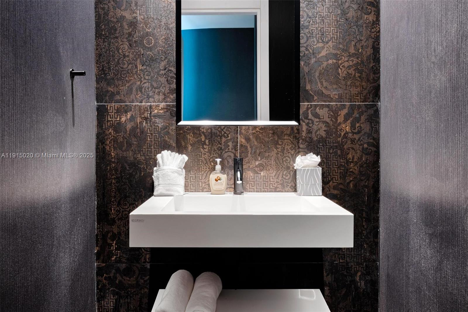 77 Southwest 18th Terrace Miami, FL 33129 - Photo 72 of 90 a bathroom with a sink a toilet and mirror