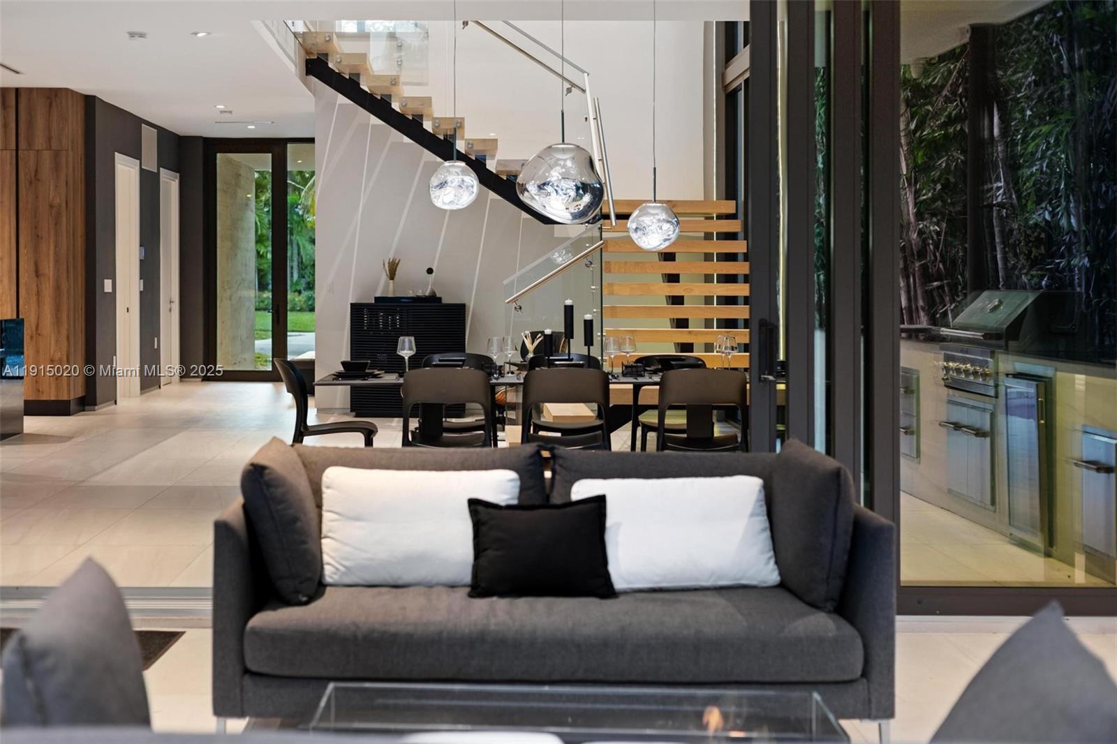 77 Southwest 18th Terrace Miami, FL 33129 - Photo 80 of 90 a living room with furniture a large window and a fireplace