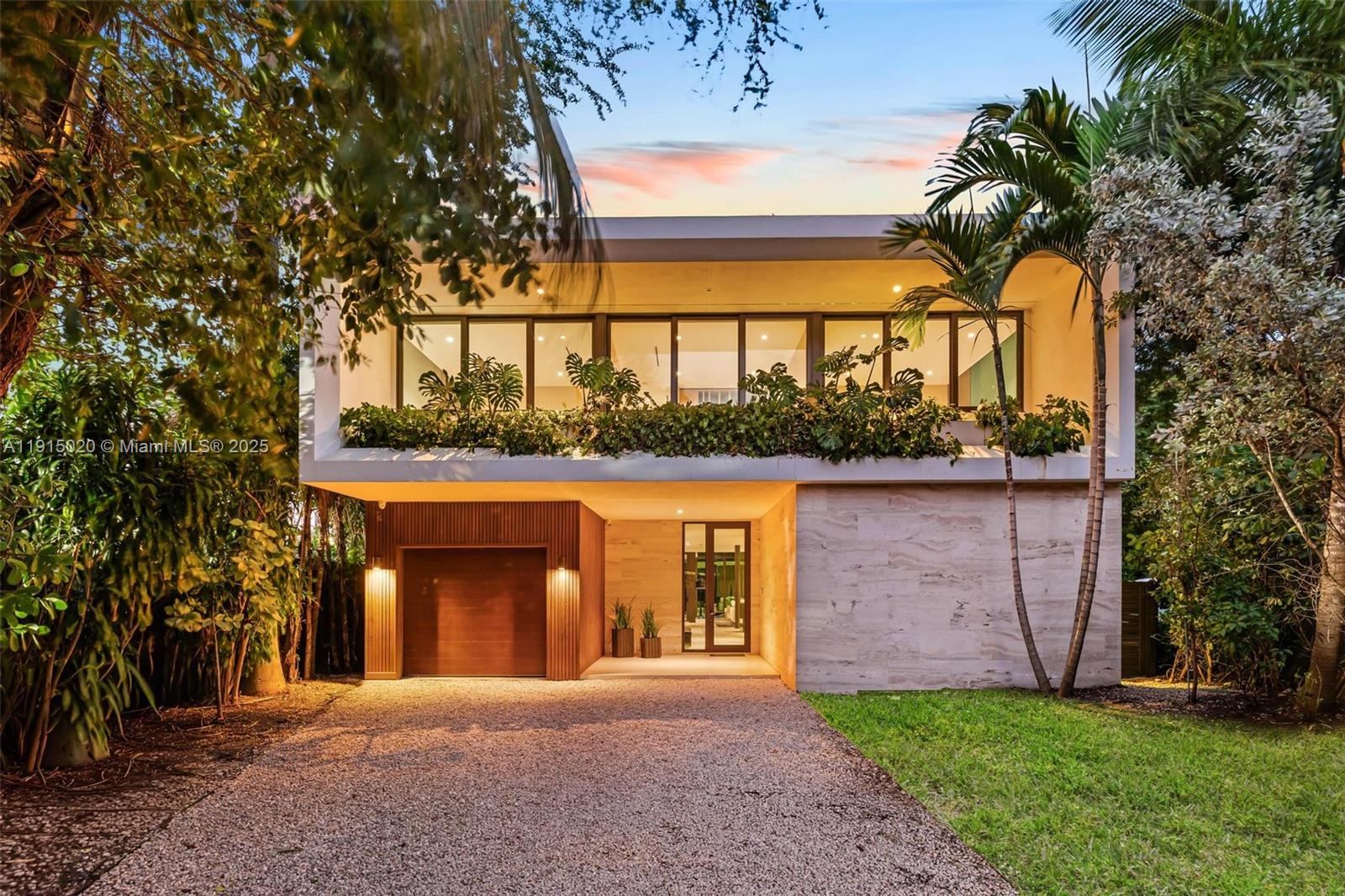 77 Southwest 18th Terrace Miami, FL 33129 - Photo 87 of 90 a front view of a house with a yard and garage