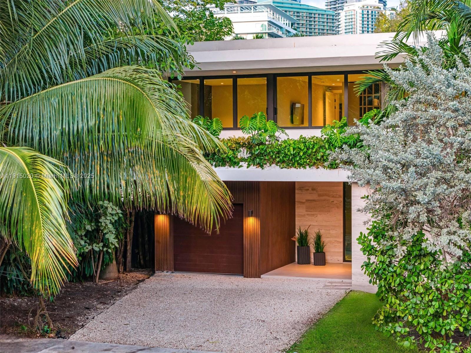 77 Southwest 18th Terrace Miami, FL 33129 - Photo 89 of 90 a front view of a house with a garden