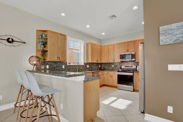 a kitchen with stainless steel appliances granite countertop a stove and a sink
