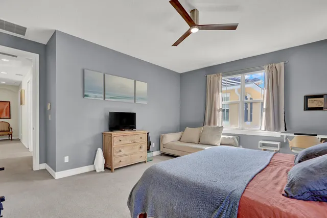 a bedroom with two beds and a large window