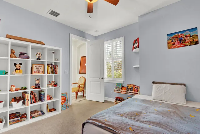 a bedroom with furniture and a book shelf