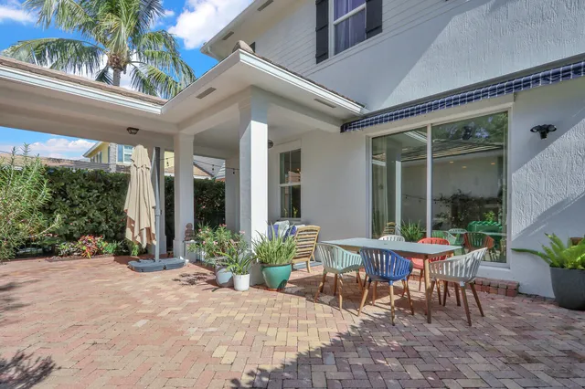 a view of a patio with table and chairs and potted plants