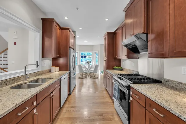 a kitchen with a sink stove top oven and cabinets