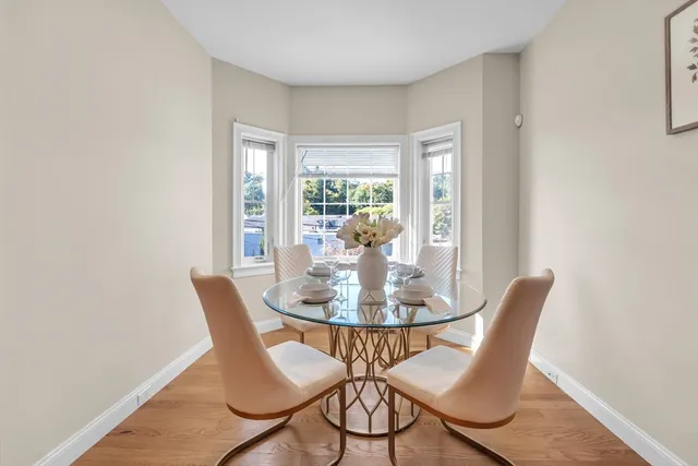 a dining room with furniture and window