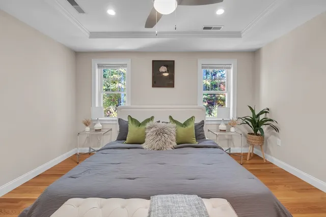 a spacious bedroom with a large bed and a potted plant