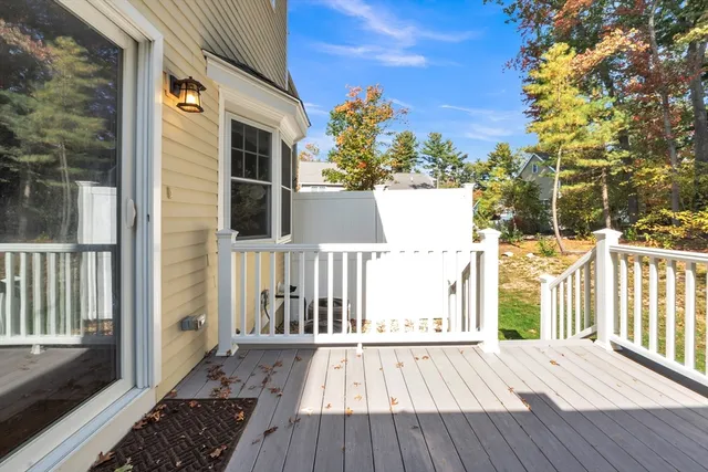 a view of a brick house with wooden floor and fence