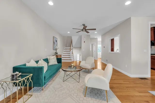 a living room with furniture and a wooden floor