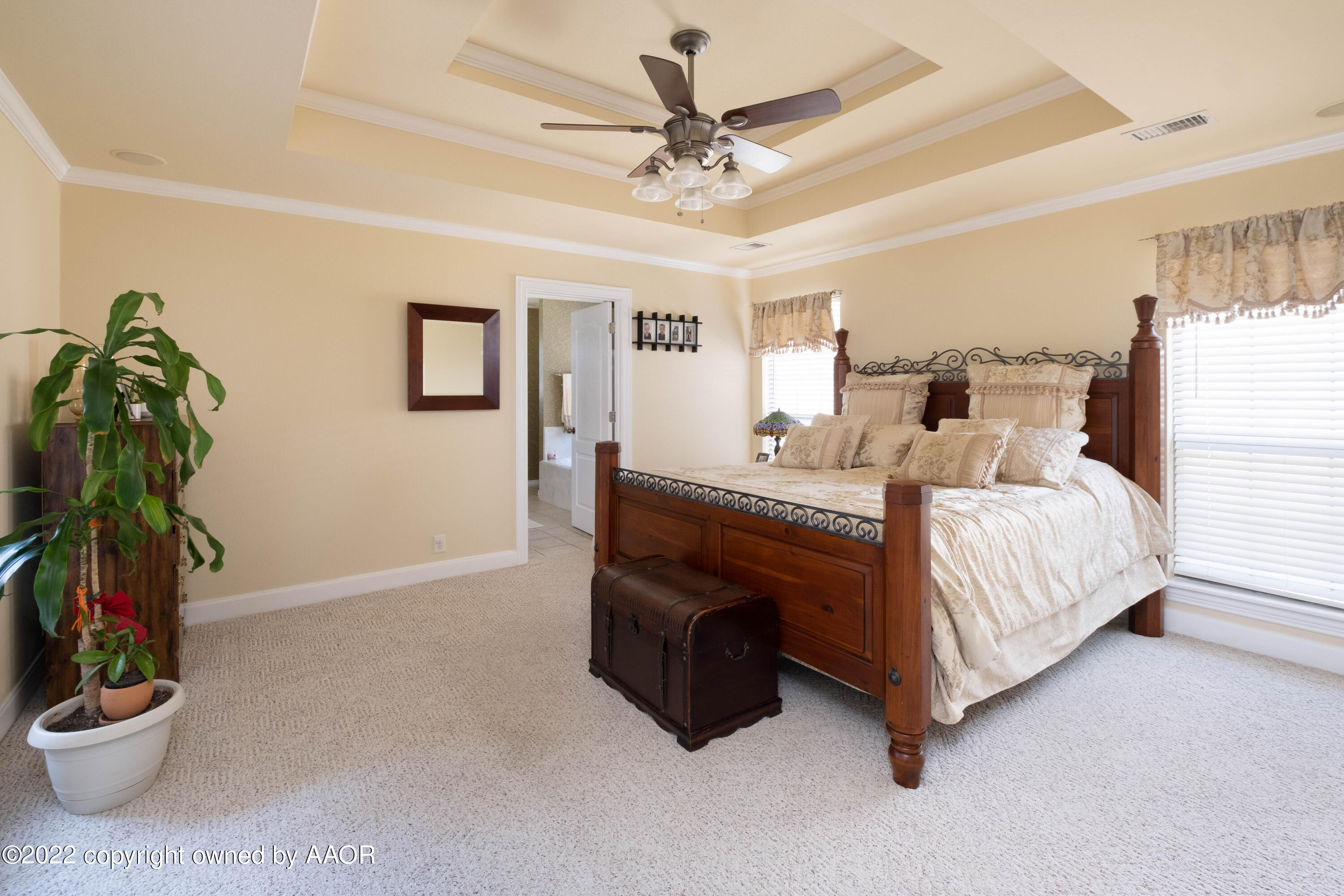 6607 Rally Road Amarillo, TX 79119 - Photo 17 of 34 a bedroom with a bed and a chandelier