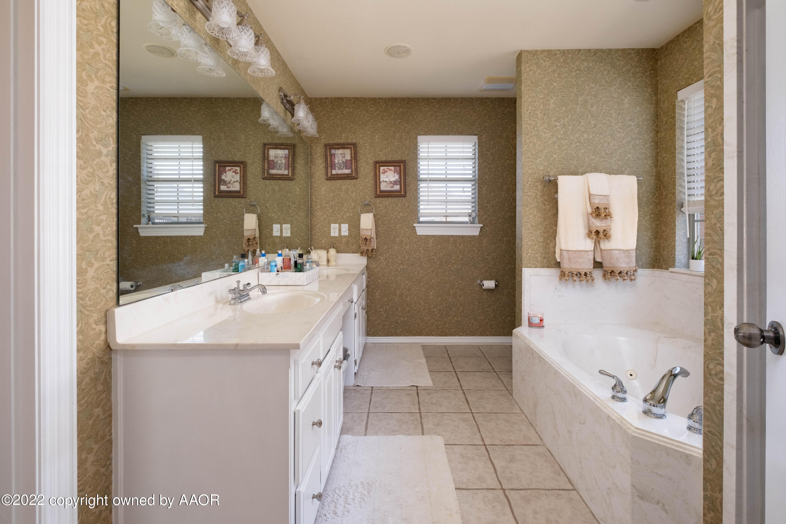 6607 Rally Road Amarillo, TX 79119 - Photo 19 of 34 a bathroom with a sink a toilet and mirror
