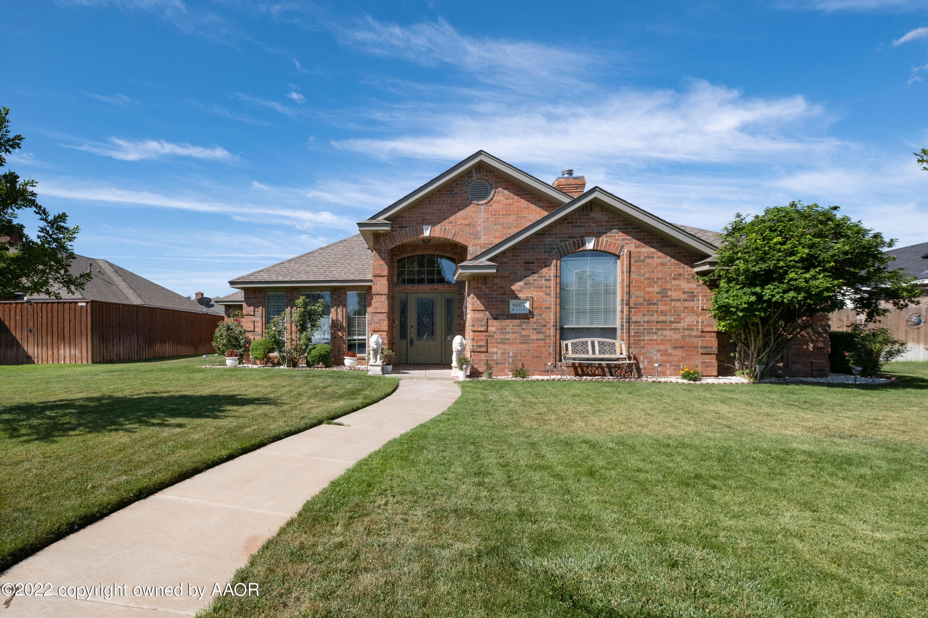 6607 Rally Road Amarillo, TX 79119 - Photo 2 of 34 a front view of a house with a yard and garage