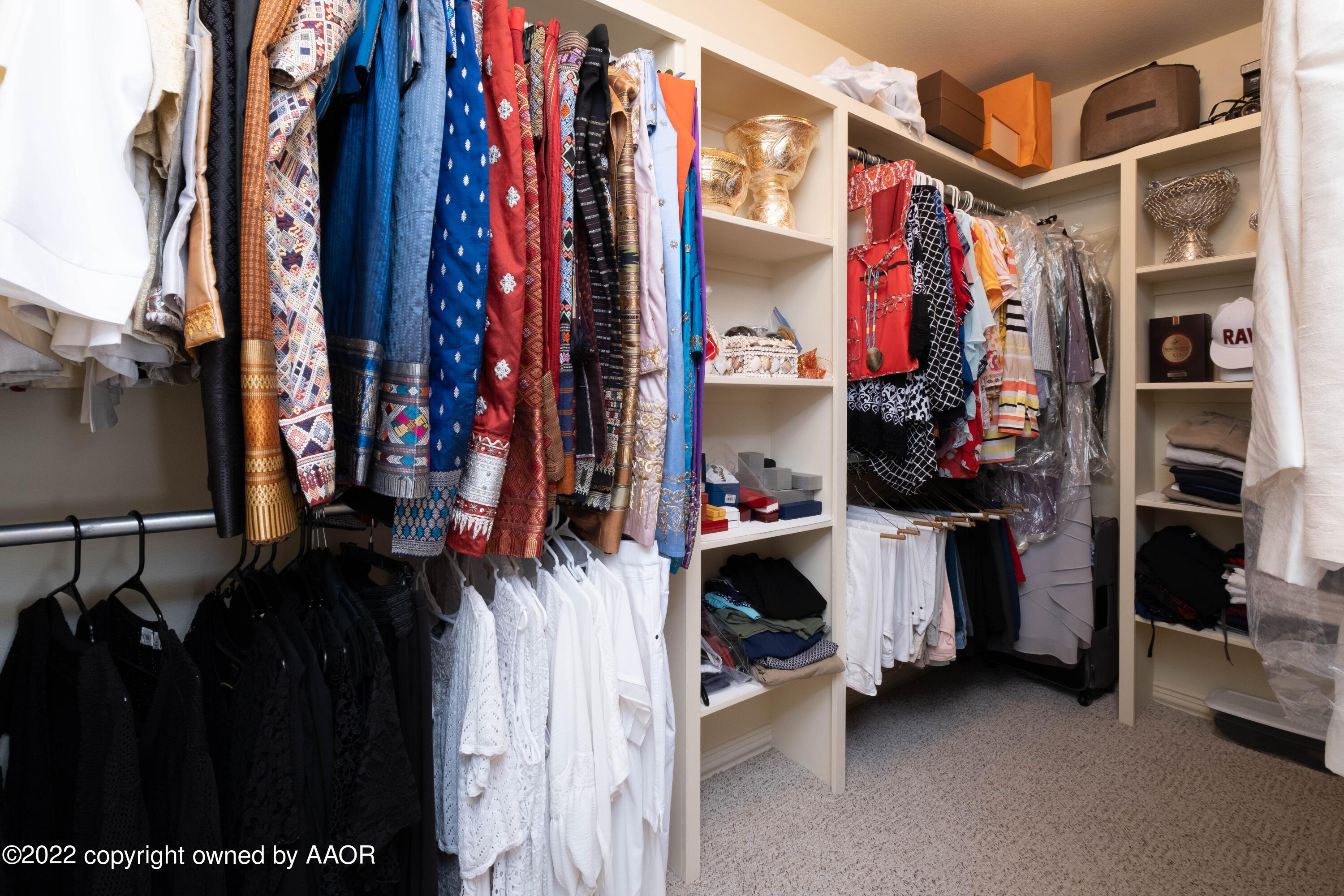 6607 Rally Road Amarillo, TX 79119 - Photo 22 of 34 a view of walk in closet with clothes and shoes