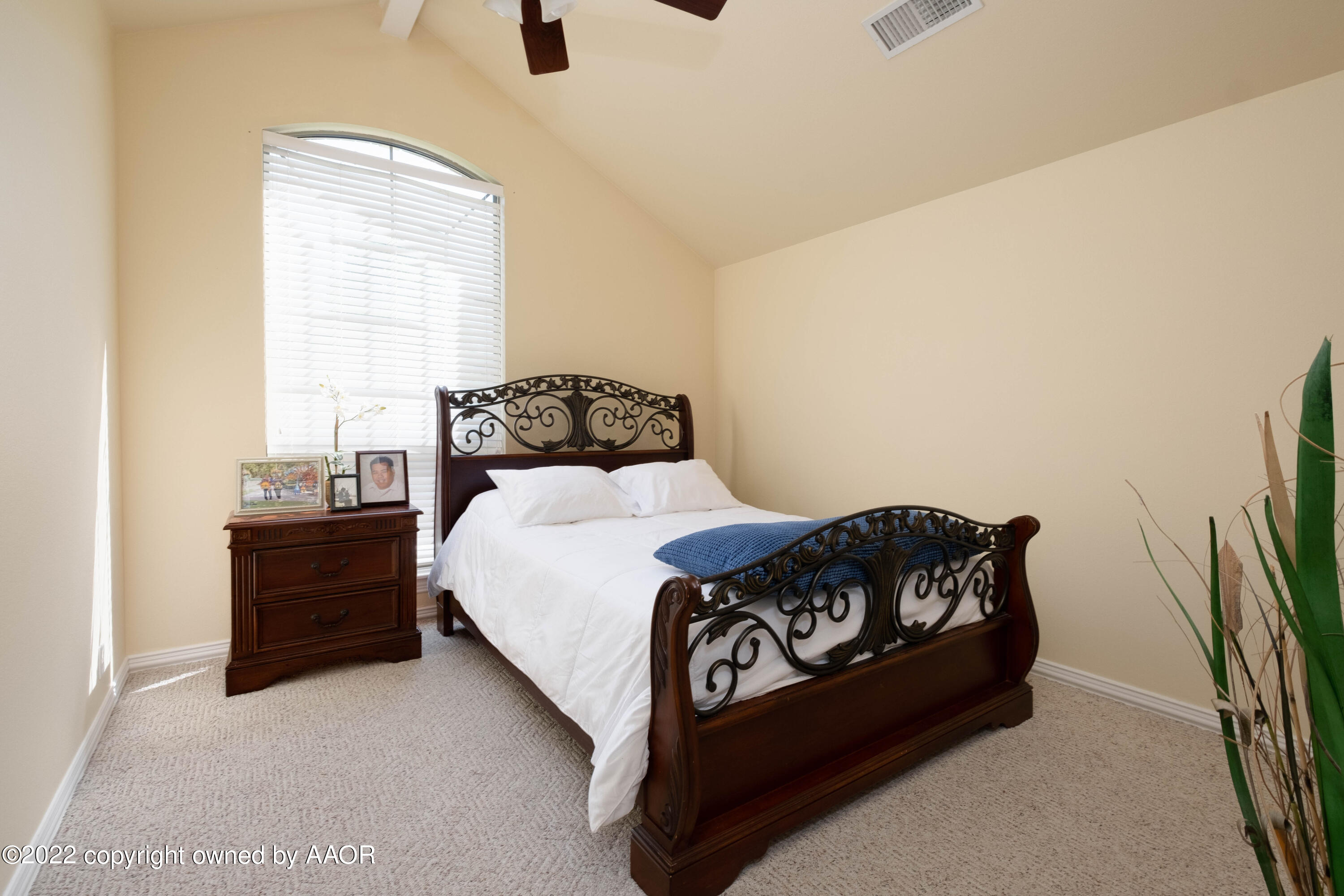 6607 Rally Road Amarillo, TX 79119 - Photo 23 of 34 a bedroom with a bed and a flat tv screen on a dresser