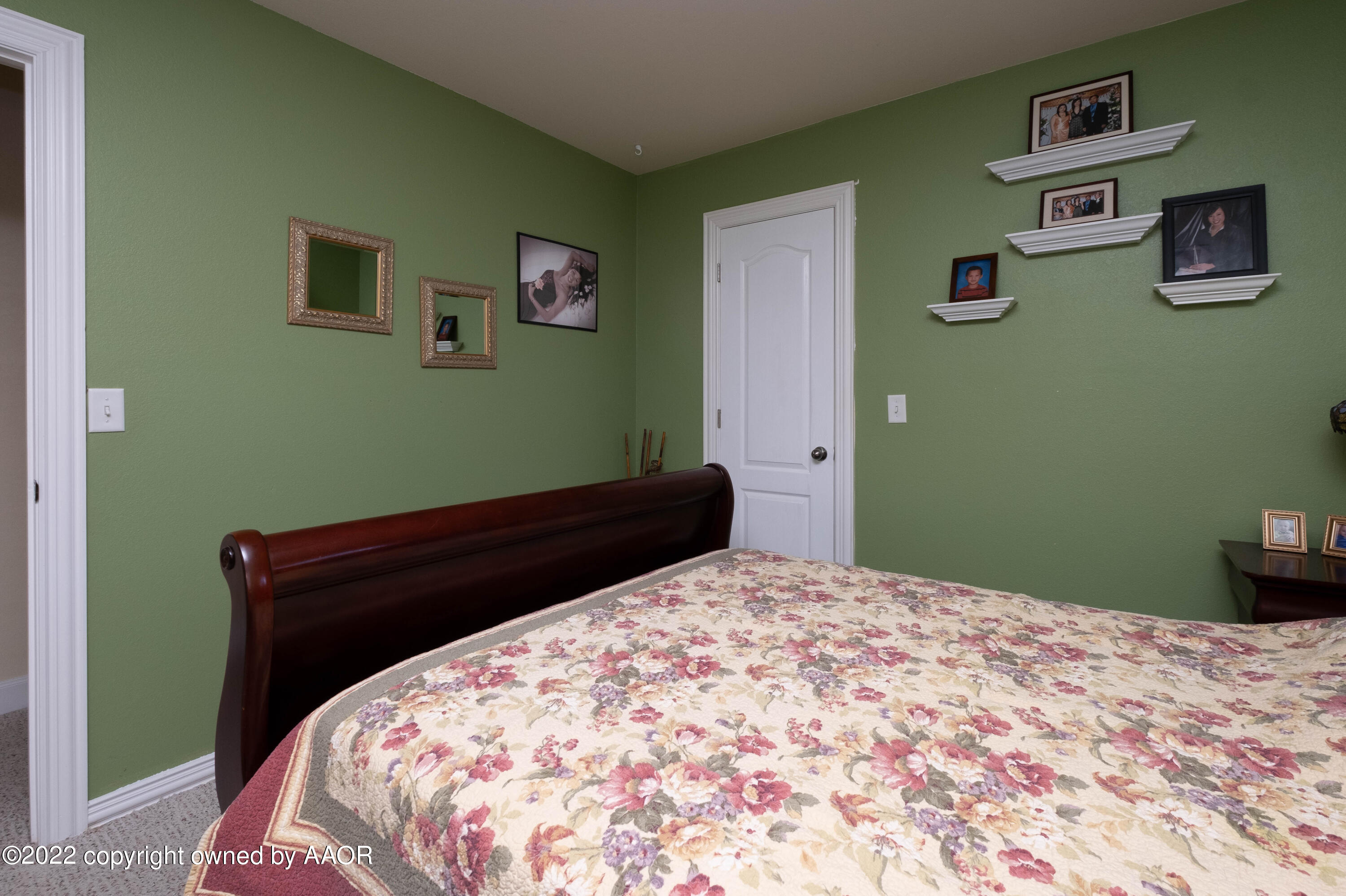 6607 Rally Road Amarillo, TX 79119 - Photo 26 of 34 a bedroom with a bed and painting on the wall