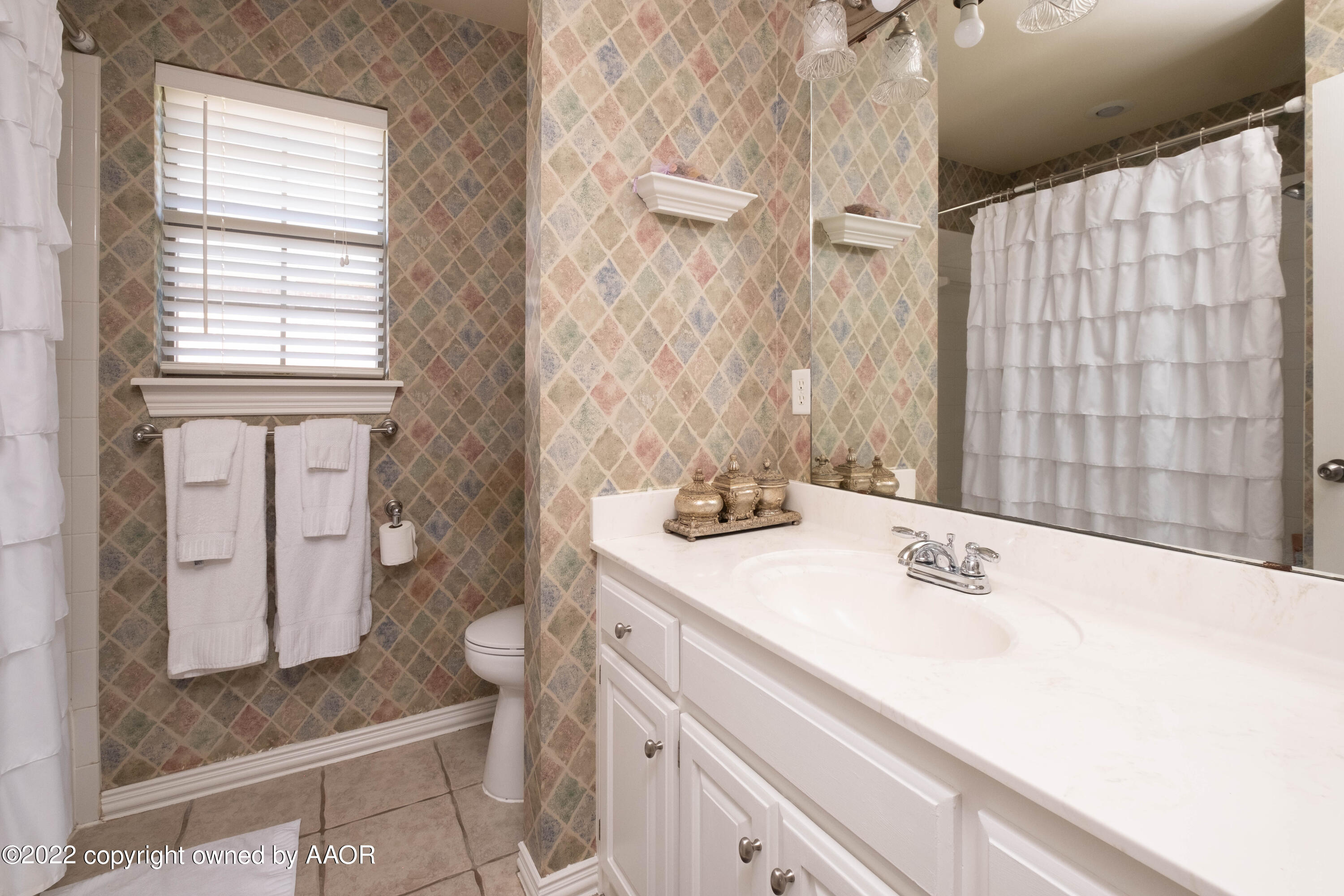 6607 Rally Road Amarillo, TX 79119 - Photo 27 of 34 a bathroom with a sink and a mirror