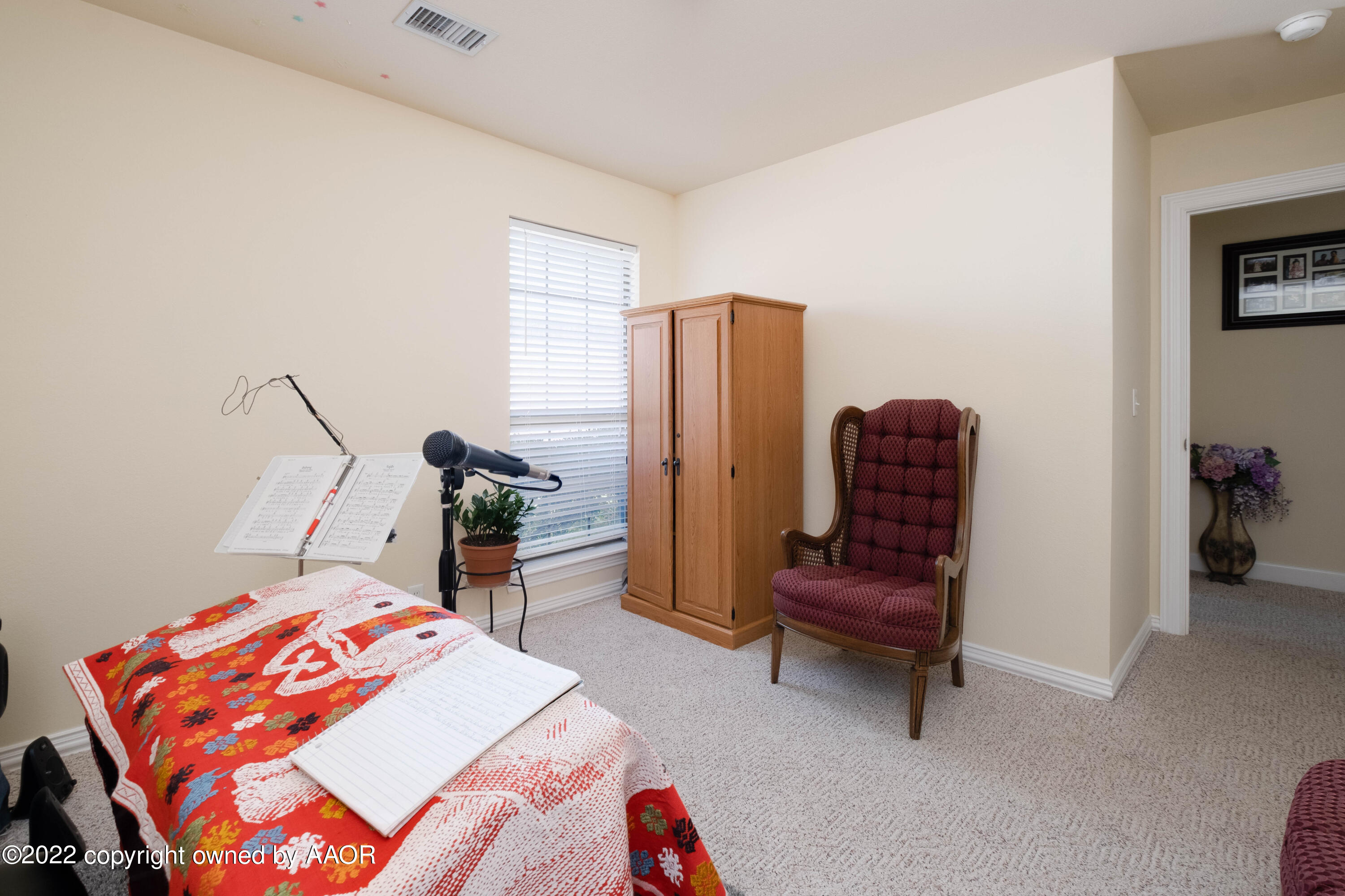 6607 Rally Road Amarillo, TX 79119 - Photo 28 of 34 a bedroom with a bed and a chair