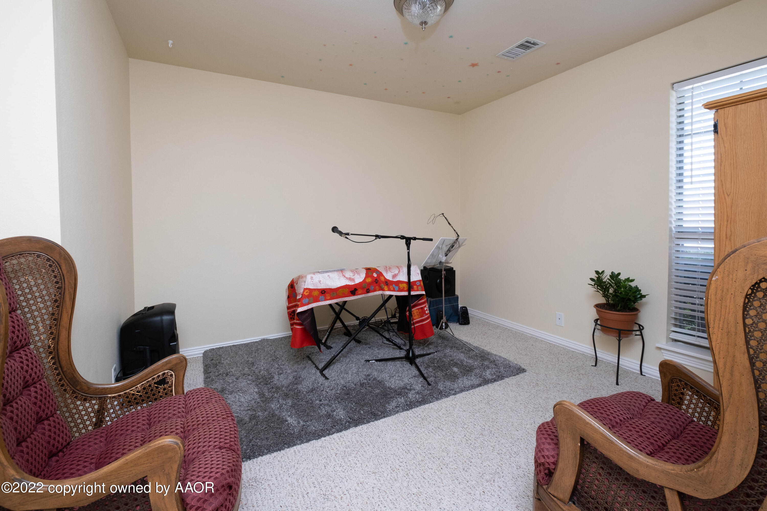 6607 Rally Road Amarillo, TX 79119 - Photo 29 of 34 a living room with furniture a rug and a chair